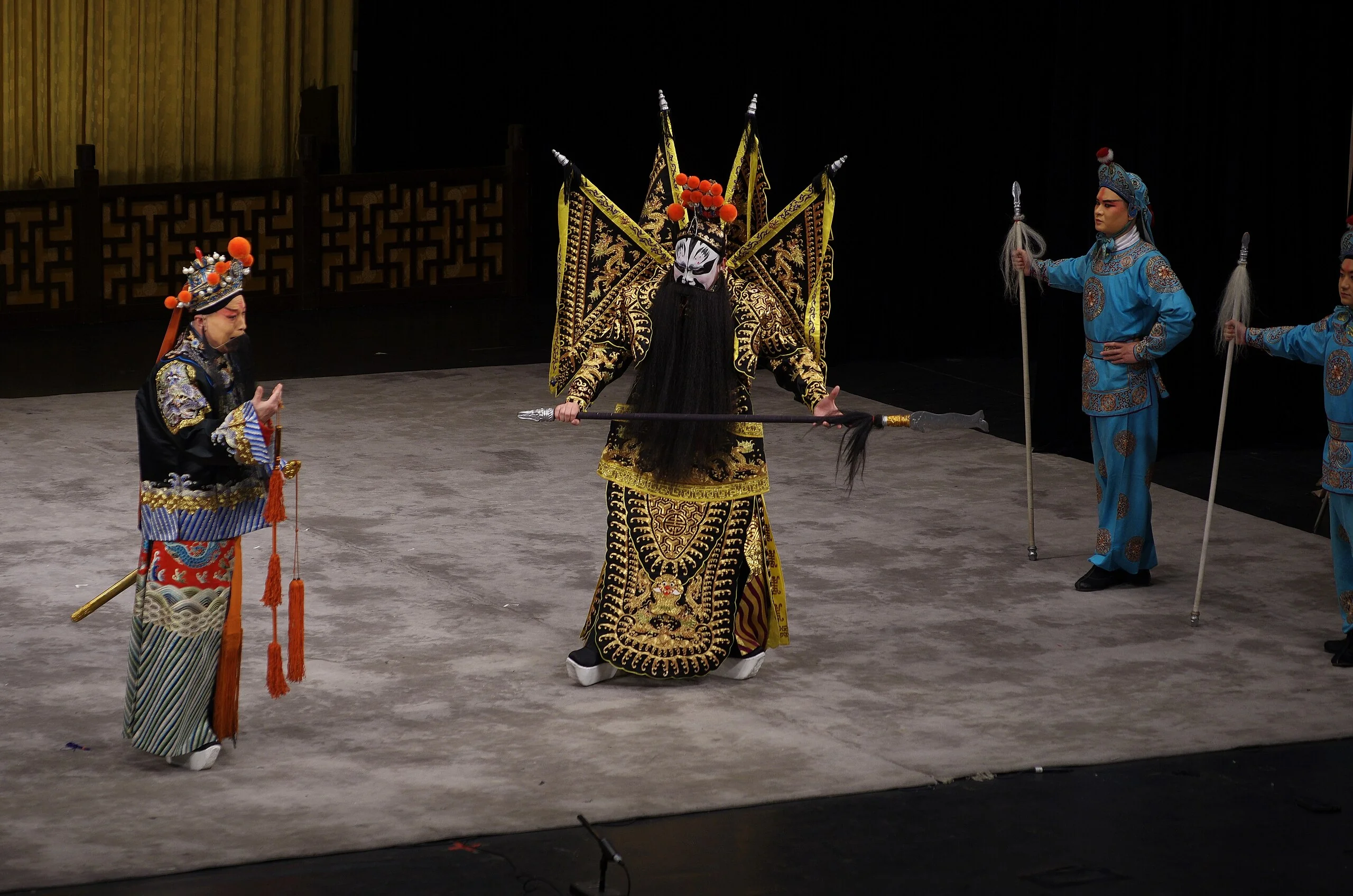 Peking Opera performers in traditional costumes on stage